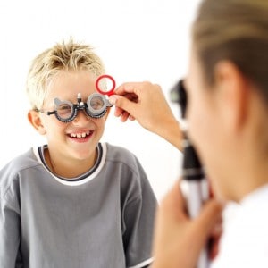 Young Medical Professional Checking the Eyes of Young Boy (8-10)