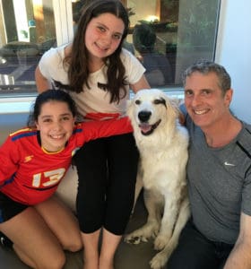 Dr. Brian and his daughters with Roxy who they rescued.